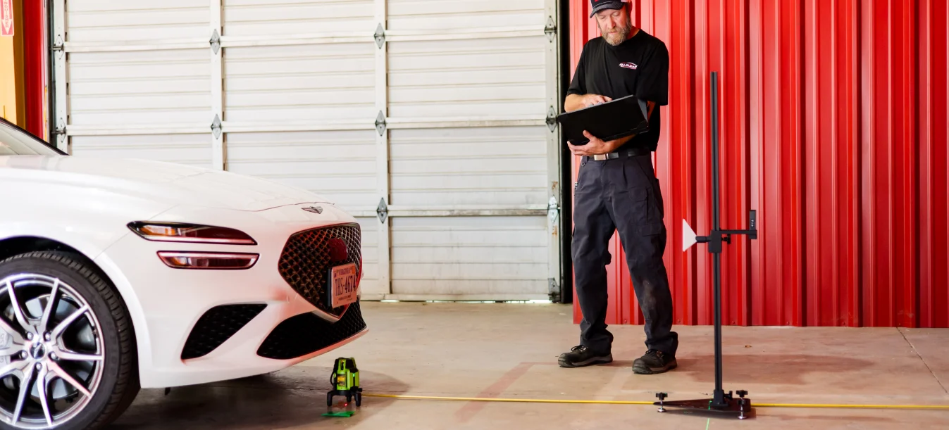 Technician calibrating ADAS with tablet